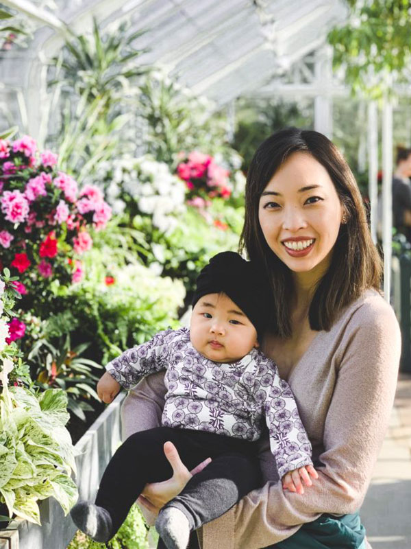 Kristen and son in a greenhouse.