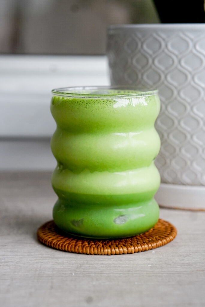 creamy matcha latte in a glass cup