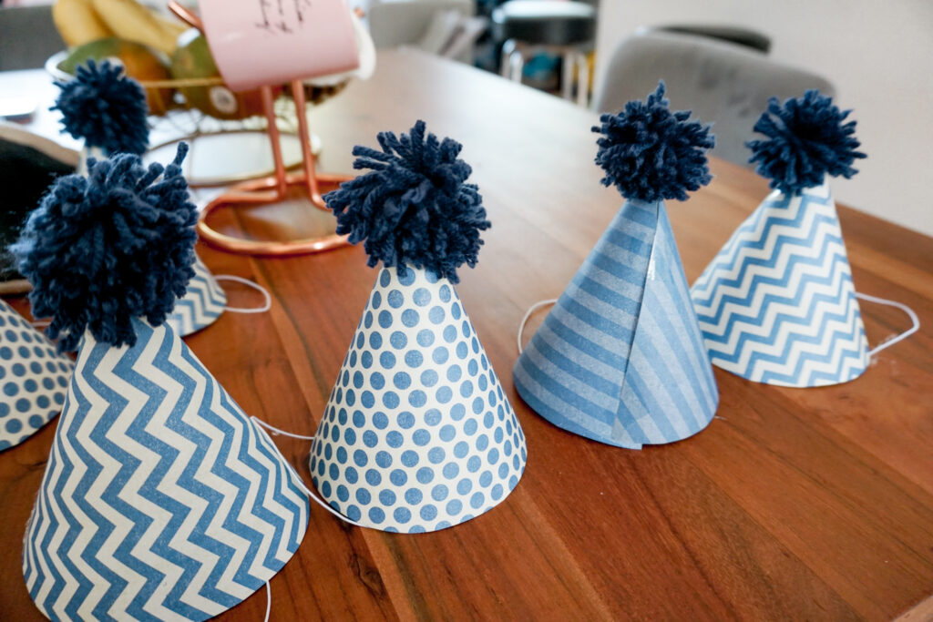 DIY party hats with DIY pom poms