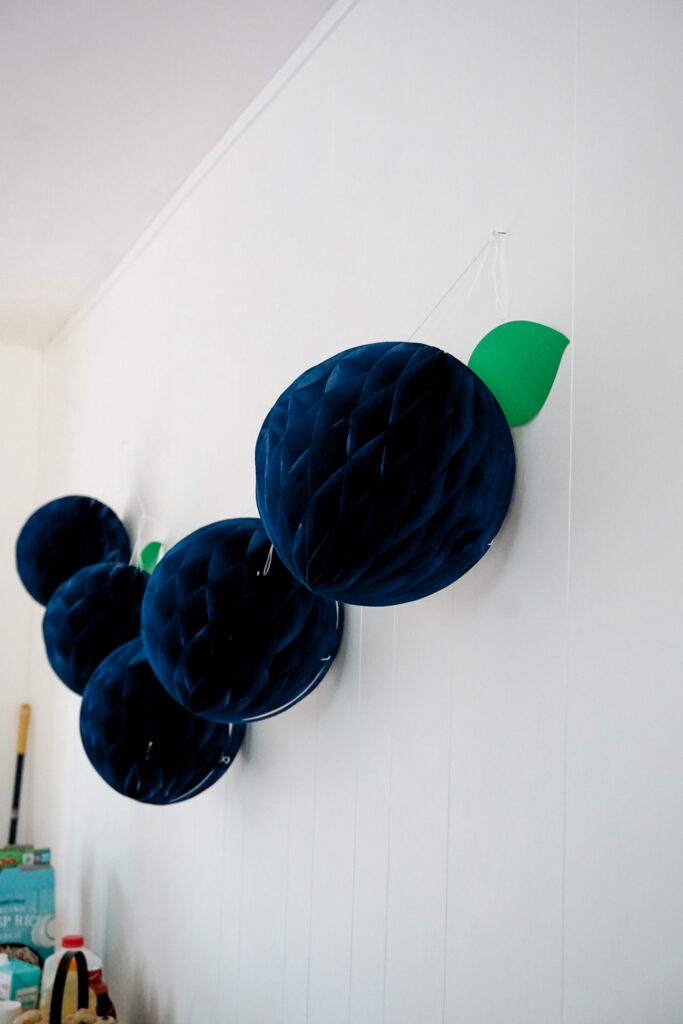 DIY blueberry garland party decorations made from paper honeycomb balls 