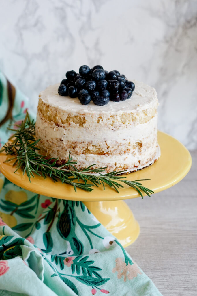 6" three layer lemon naked cake with blueberries on top and rosemary on the side