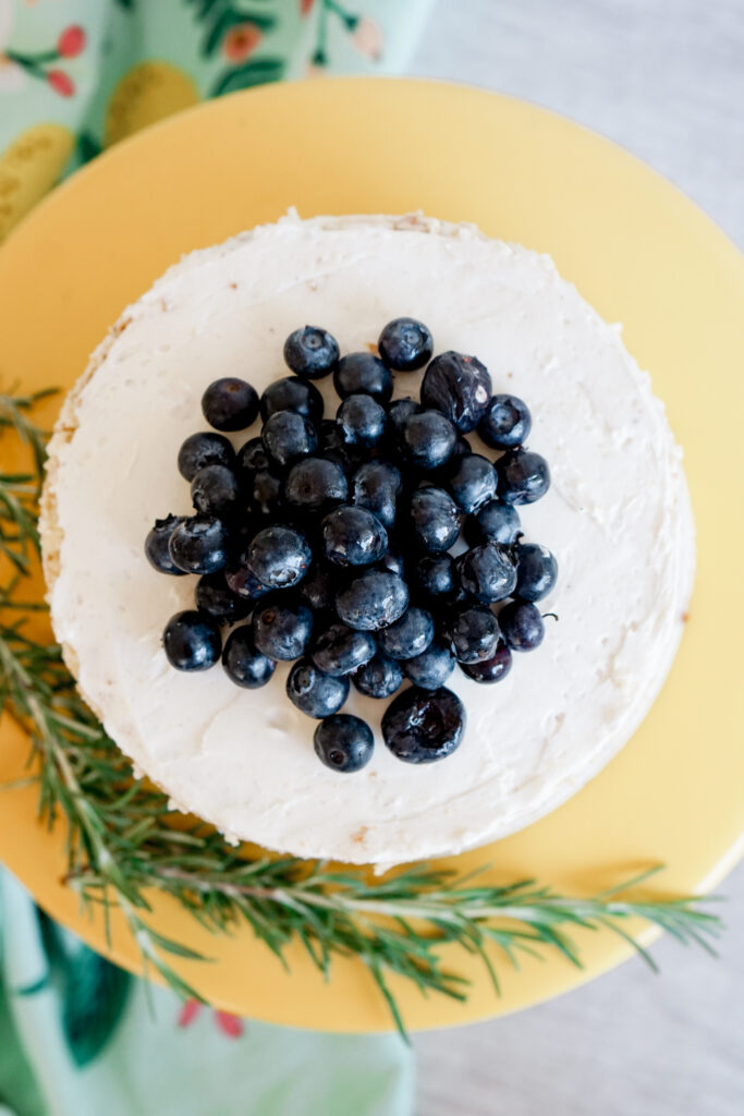 6" three layer lemon naked cake with blueberries on top and rosemary on the side