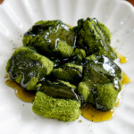 matcha warabimochi on a plate with syrup