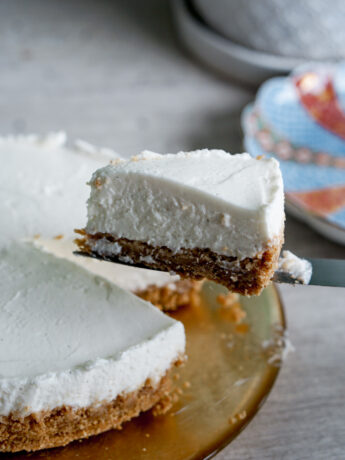 no-bake yogurt cheesecake slice held up by a knife