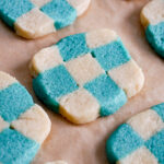 closeup of blue checkerboard cookies on a baking tray