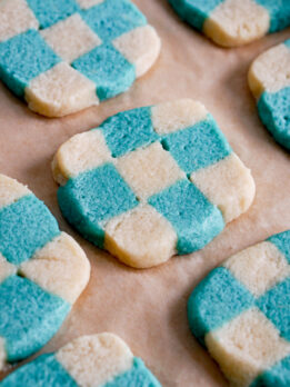 closeup of blue checkerboard cookies on a baking tray