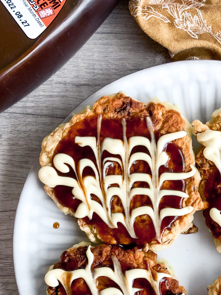 mini okonomiyaki with sauce and mayonnaise in a pattern