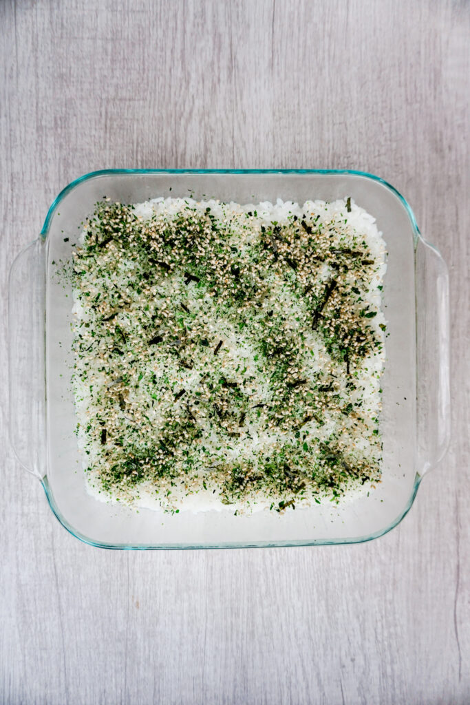 Rice and nori furikake in a baking dish.