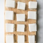 overhead view of squares of haupia on a wood cutting board