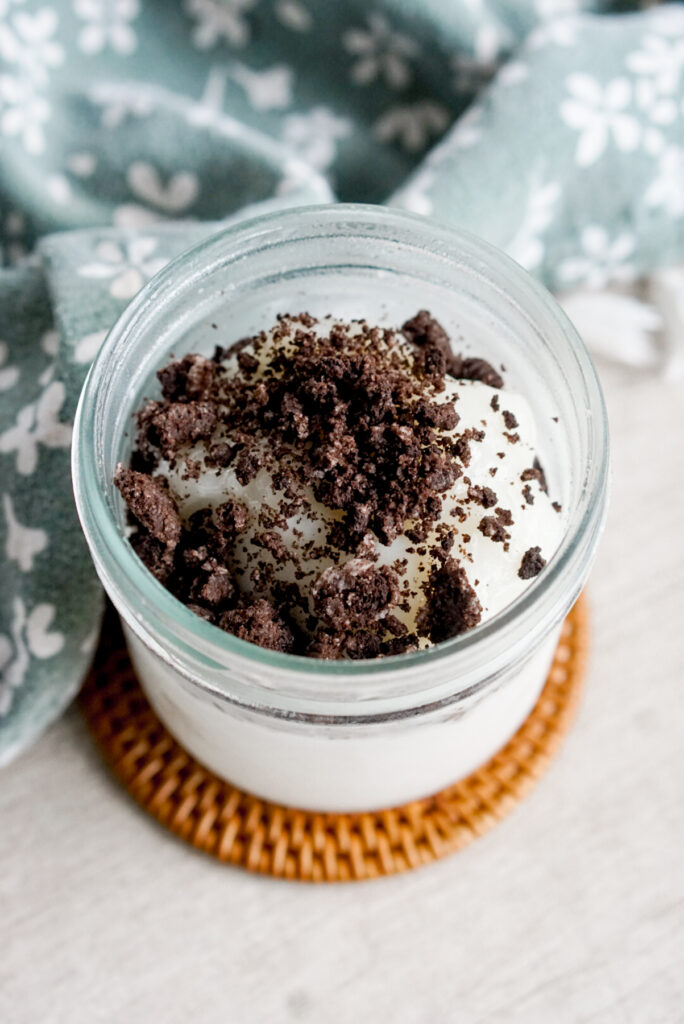melo melo coconut jelly dessert copycat recipe overhead shot of glass jar with oreo crumbs