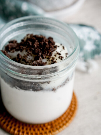 melo melo coconut jelly dessert copycat recipe in a glass jar with oreo crumbs on top