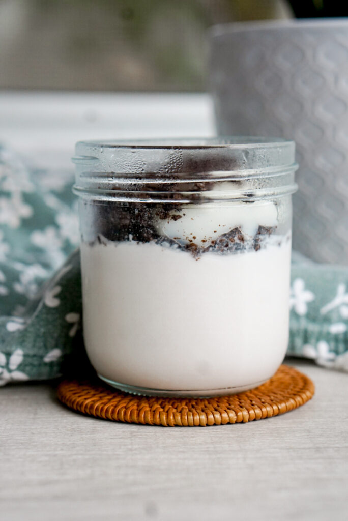 melo melo coconut jelly dessert copycat recipe in a glass jar with oreo crumbs on top