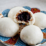 steamed red bean bun stacked in pyramid with top cut in half to see red beans inside