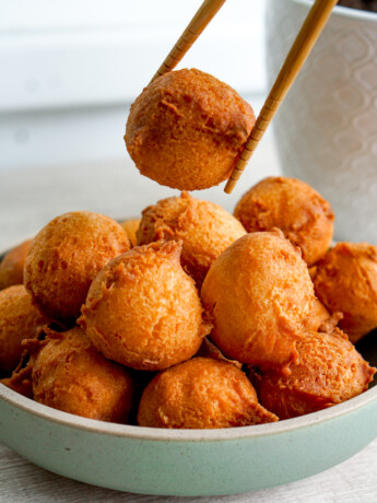 sata andagi held up with chopstick