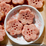 strawberry shortbread cookie dough cut in cherry blossom shape in a small white dish