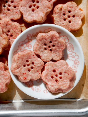 strawberry shortbread cookie dough cut in cherry blossom shape in a small white dish