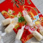 wrapped white milk candies on top of chinese new year red envelope
